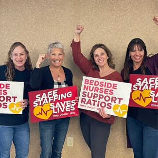 Four nurses holdiing signs "Safe Staffing Saves Lives"